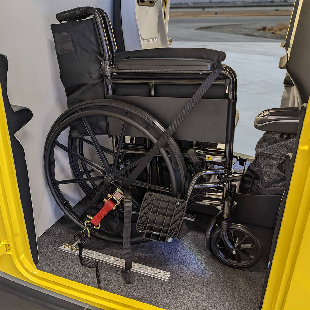 Research volunteer tests placement of grips for passengers in wheelchairs and provides valuable feedback